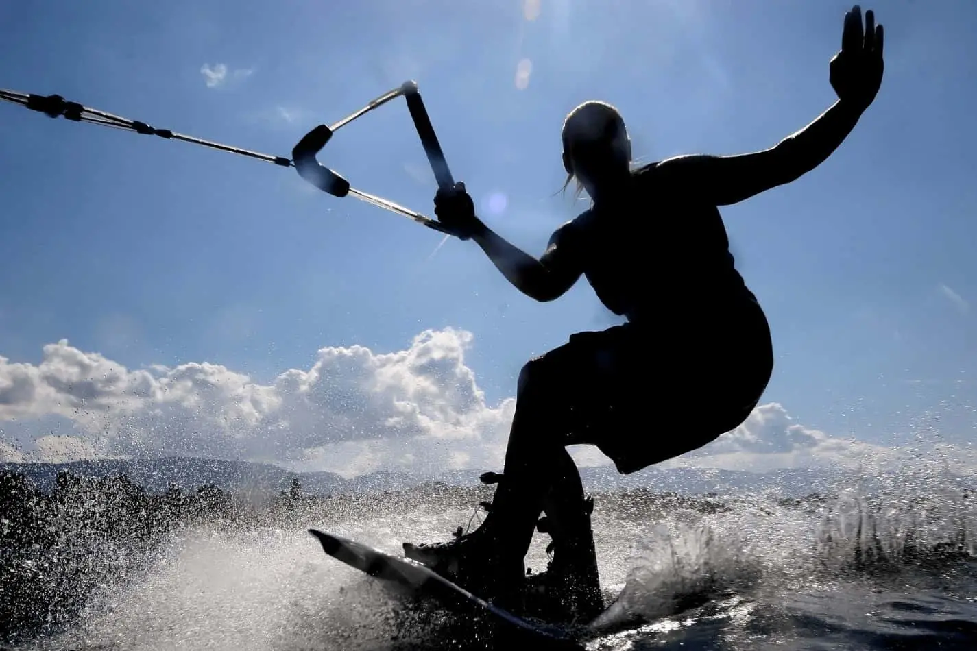 Close up of a man wakeboarding on a sunny day