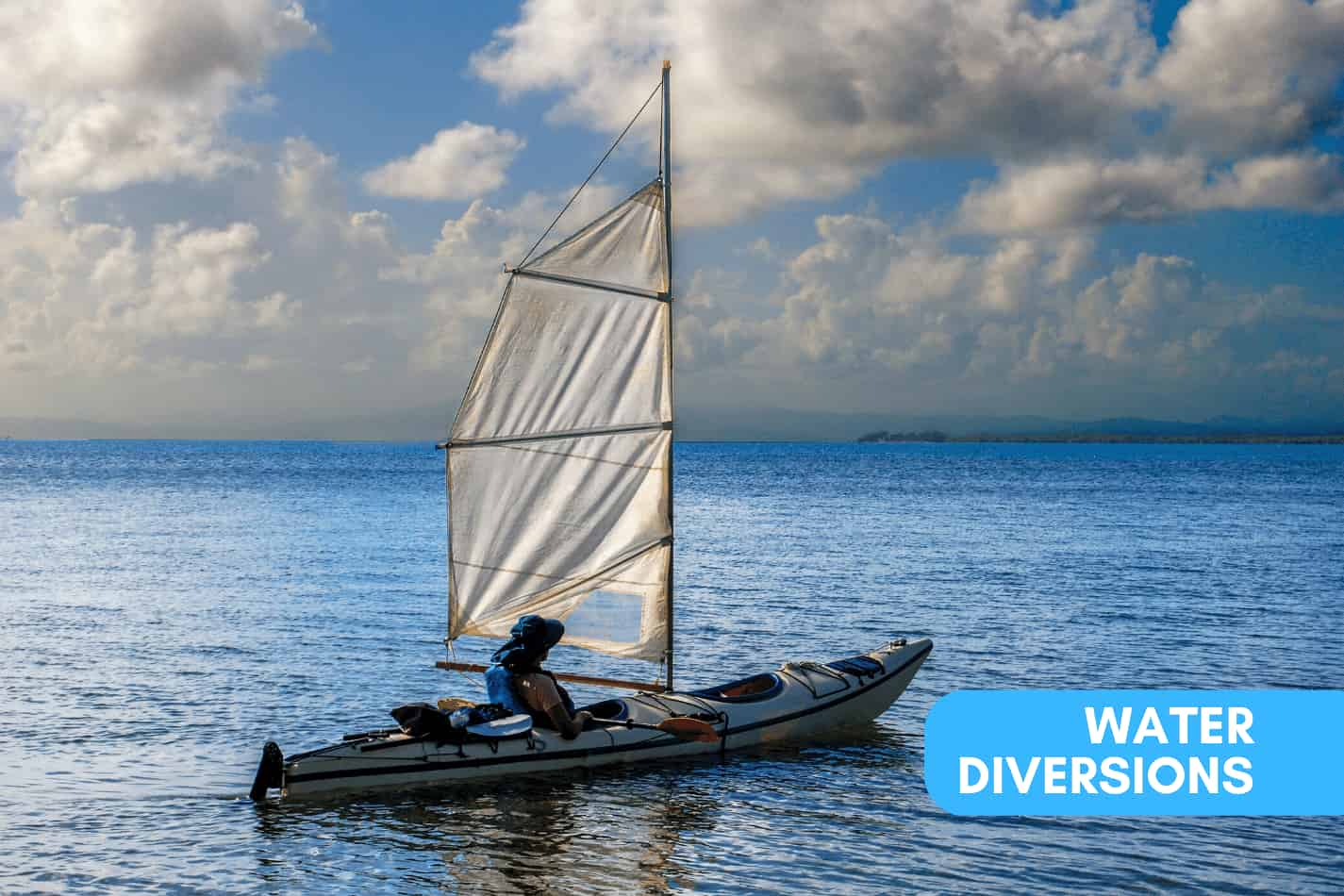 Kayak with a sail on the open water for easier travels