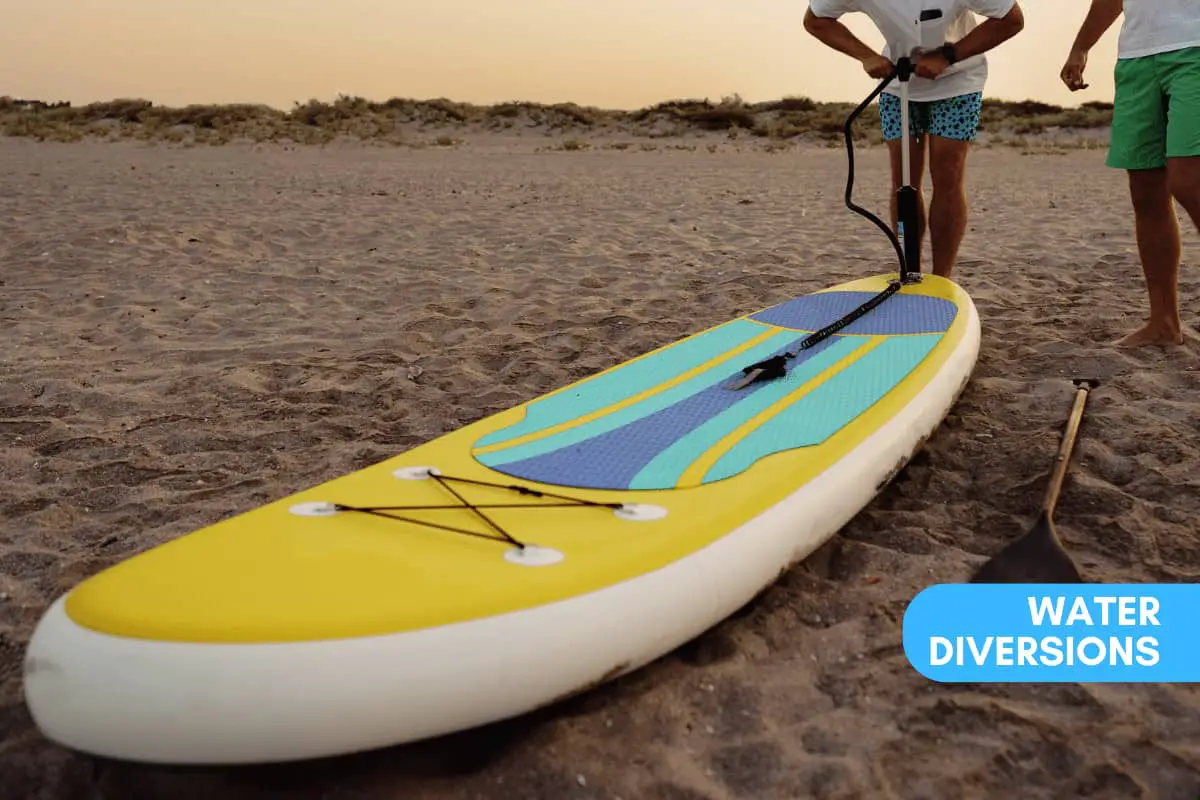 Inflating an iSUP on the beach to ride